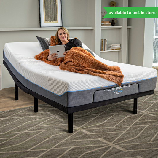 Woman relaxing on Adjustapedic 5.0 adjustable bed with tablet