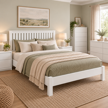 Load image into Gallery viewer, A white wooden bed frame with a slatted headboard, styled with sage green and cream bedding, a textured beige throw blanket, and styled in a bright, modern bedroom with a matching woven rug.