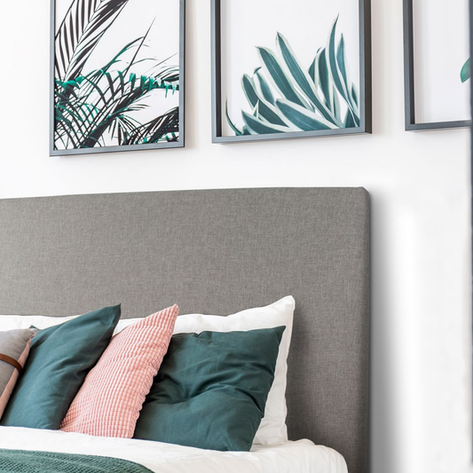 Nowra upholstered bedhead in light neutral fabric styled in bedroom setting